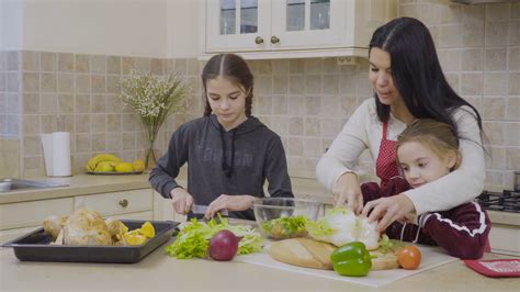 Daughters Help Mother To Cook The Dinner Stock Video Footage Sbv