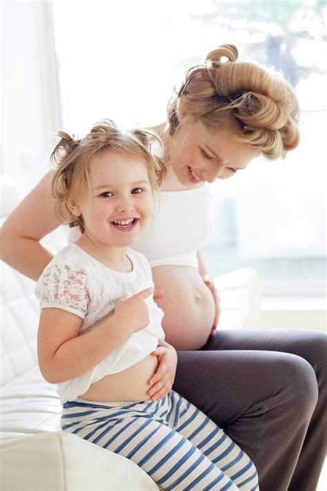 Pregnant Woman And Daughter Smiling Photograph By Ian Hootonscience Photo Library Fine Art
