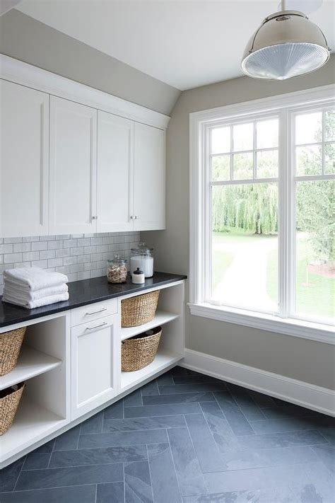 White Laundry Cabinets With Gray Slate Herringbone Floor Transitional