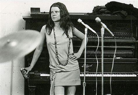 A Woman Standing Next To Microphones In Front Of A Piano