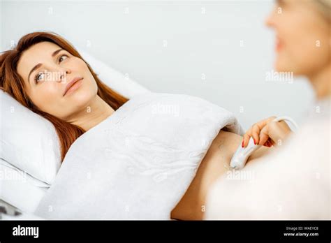 Woman Examining Her Pelvic Organs With Ultrasound Sensor Or Diagnosing Early Pregnancy At The