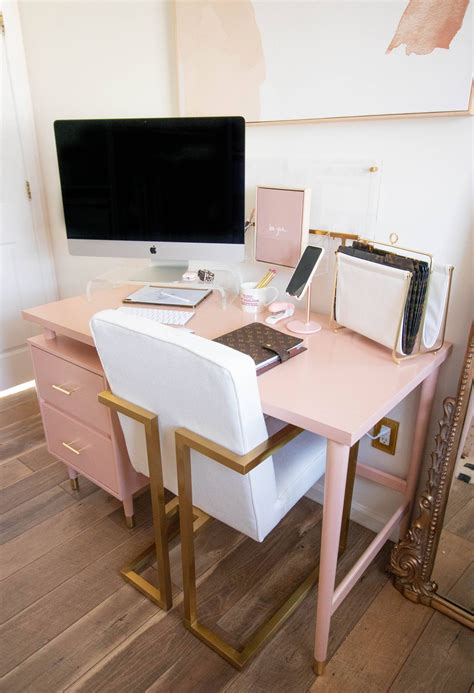 A Pink Desk Topped With A Laptop Computer Next To A White Chair And