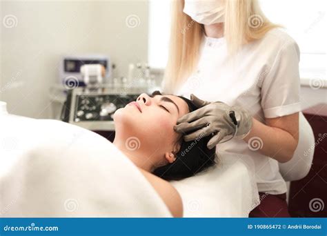 Doctor Cosmetologist Sets Up The Device For Cosmetic Procedures Stock