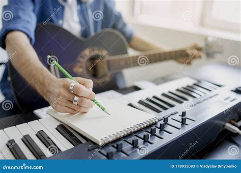 Male Music Arranger Composing Song On Midi Piano And Audio Equipment In