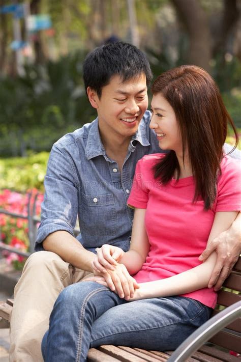 Young Chinese Couple Relaxing In Park Together Stock Photo Image Of