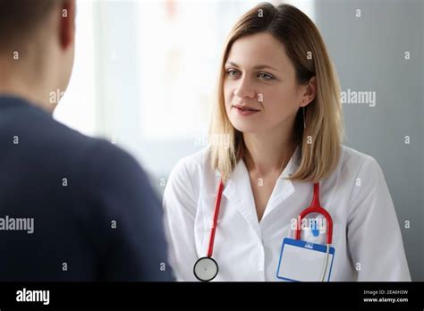 Woman Doctor Talking To Patient In Clinic Stock Photo Alamy