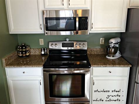 The white stainless steel cabinets strike through the heavy silver stainless steel and create breezy and bright feel in the place. stainless steel | granite | white cabinets (With images) | Kitchen remodel, White cabinets, Kitchen