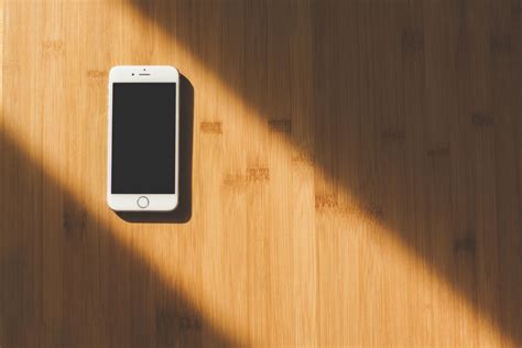 White Apple Iphone On Wooden Table · Free Stock Photo