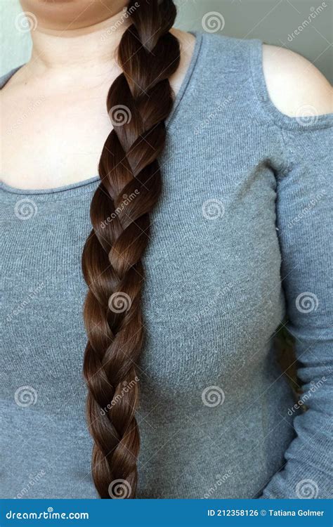 Young Woman Brunette Braids Her Long Beautiful Hair In A Thick Braid Concept Of Hygiene Hair