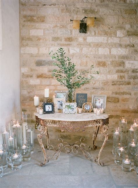 An Image Of A Table With Flowers On It And Candles Next To It As Well As Photos