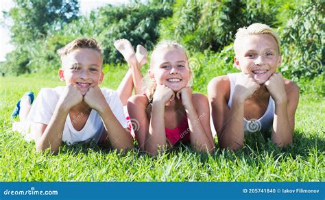 Happy Kids Laying On Grass Stock Photo Image Of Positivity 205741840