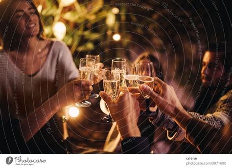 Group Of People Cheering And Celebrating With Champagne Glasses At