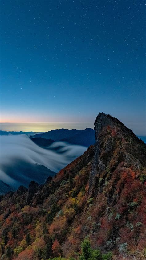 750x1334 Resolution Fog Covering Horizon Mountains Under Blue Sky