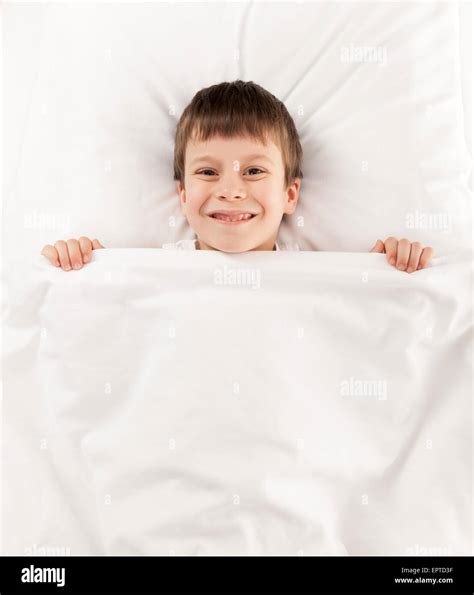 Boy Lying In Bed On White Stock Photo Alamy
