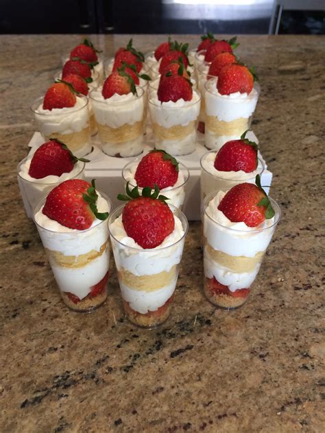 Strawberries Are Arranged On Top Of Small Desserts In Plastic Cups