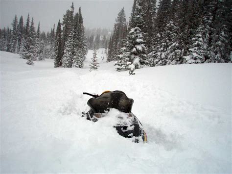 Deep Fresh Powder Snow Traps Snowmobile Near Buffalo Pass