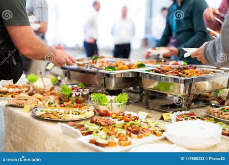 Close Up Of People Serving Themselves With Canapes In Buffet Of