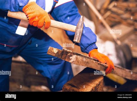 closeup of repairman in uniform professional builder working using construction equipment
