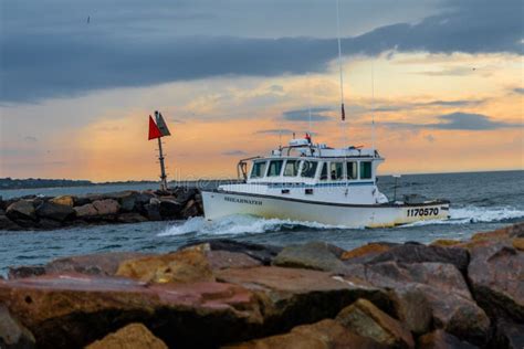 Lobster Boat Returning To A Harbor On Marthas Vineyard At Sunset