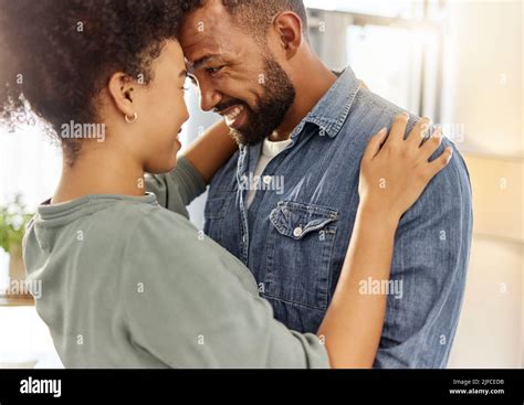 Happy Mixed Race Couple Hugging While Relaxing At Home Comfy Hispanic Husband And Wife Smiling