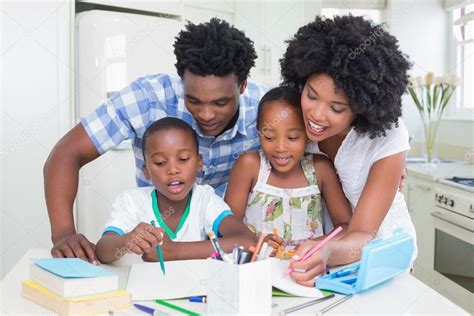 Happy Parents Helping Children With Homework Stock Photo By