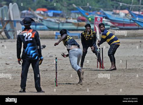 Sri Lankan Cricket Fans Play A Game Of Cricket On The Beach At Galle