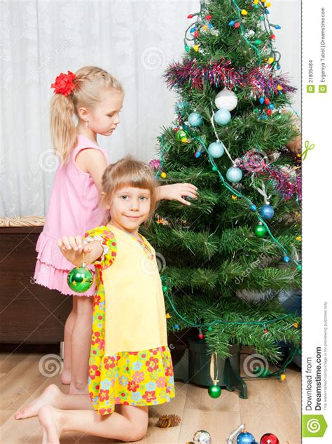 When christmas comes around, a good way to make your home feel festive is by putting up a christmas tree. Children Decorate The Christmas Tree Stock Images - Image ...