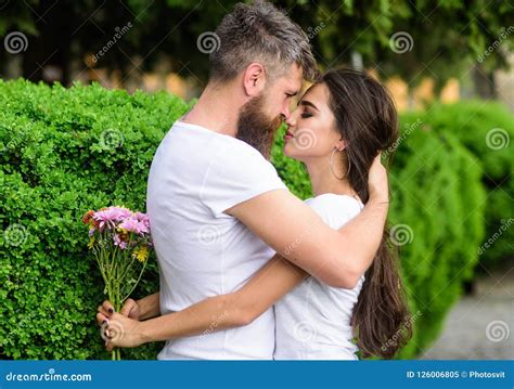 He Likes Her Gorgeous Hair Girl Holds Flowers While Man Caress Her