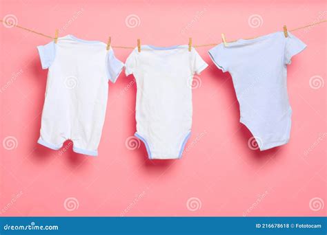 Baby Clothes On A Clothesline On Pink Background Stock Photo Image Of