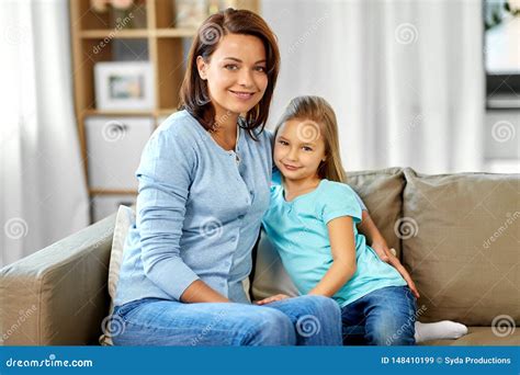 Mother And Daughter Sitting On Sofa At Home Stock Image Image Of Couch Concept 148410199