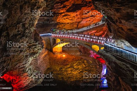 People Sightseeing Interior Of Magnificent Huanglong Yellow Dragon Cave