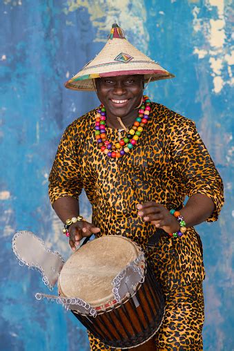 Handsome African Drummer Weared In Traditional Costume Playing On