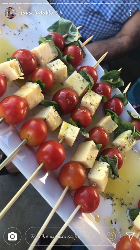 Several Skewers Of Food With Tomatoes And Cheese On Them
