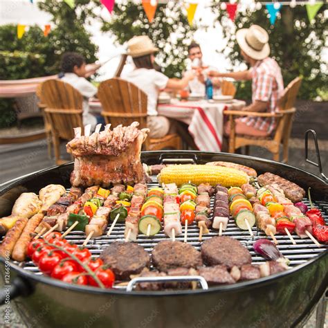 Family Having A Barbecue Party In Their Garden Stock Foto Adobe Stock
