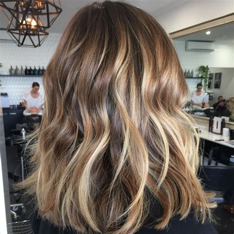 The wavy brown hair that's styled with a dash of blonde and just a bit of red will make heads turn for sure. 1001 + Ideas for Brown Hair With Blonde Highlights or Balayage
