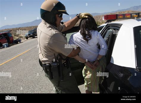 Police officer arrests female driver Stock Photo - Alamy