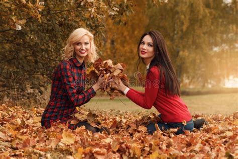 Two Beautiful Girls Friends Having Fun In Autumn Park Stock Photo