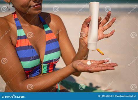 Woman In Bikini Applying Sunscreen Lotion At Beach In The Sunshine Stock Photo Image Of