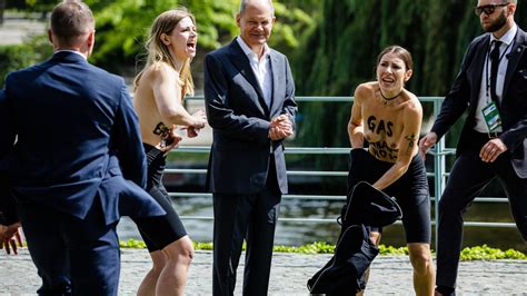 Germany Two Activists Surprise Olaf Scholz And Pose Topless To