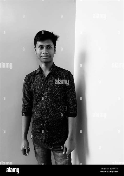 Portrait Of Young Man Standing Against Wall Stock Photo Alamy