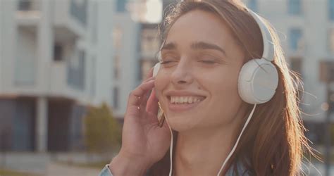 Portrait Of The Pretty Caucasian Young Woman Listening To The Music In