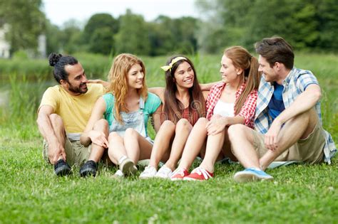 Group Of Smiling Friends Talking Outdoors Stock Image Image Of