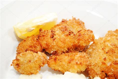 Fried catfish is an american deep south dish, coated in cornmeal and fried in oil or sometimes bacon grease. Crispy Fried Catfish Served with a Lemon Wedge — Stock ...