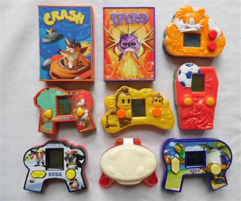 A small toy is included with the food, both of which are usually contained in a red cardboard box with a yellow smiley face and the mcdonald's logo. Happy Meal Toys At Mcdonalds - Bookmark Milfs
