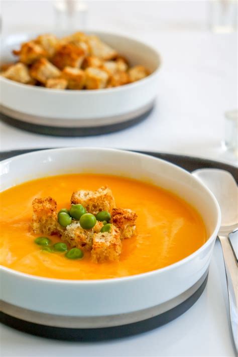 Cream Of Carrot Soup With Green Peas And Garlic Croutons