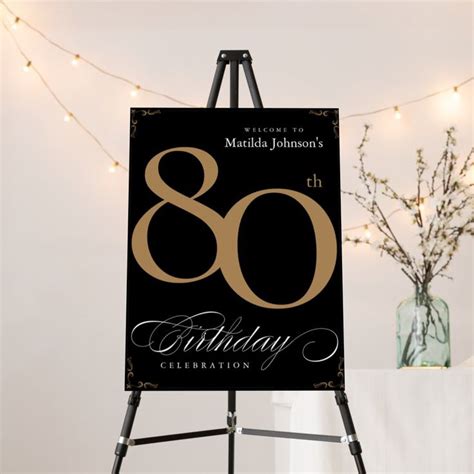 An Easel With A Sign That Says 80th Birthday Celebration In Gold On It