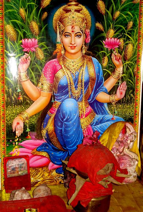 A Painting Of The Hindu God Sitting In Front Of Some Flowers And Other
