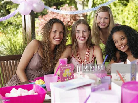 Four Teenage Girls At Birthday Party Smiling Outdoors High Res Stock