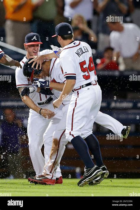 atlanta braves shortstop andrelton simmons second from right is mobbed by teammates kris