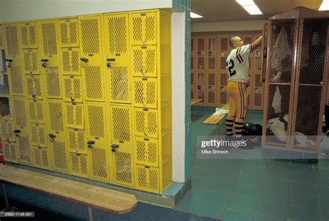 High School Football Player Standing In Locker Room Photo Getty Images